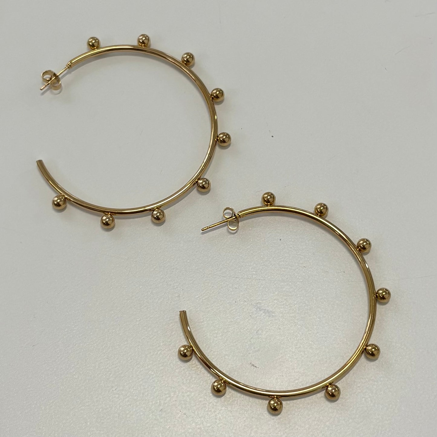 Golden round spike earrings