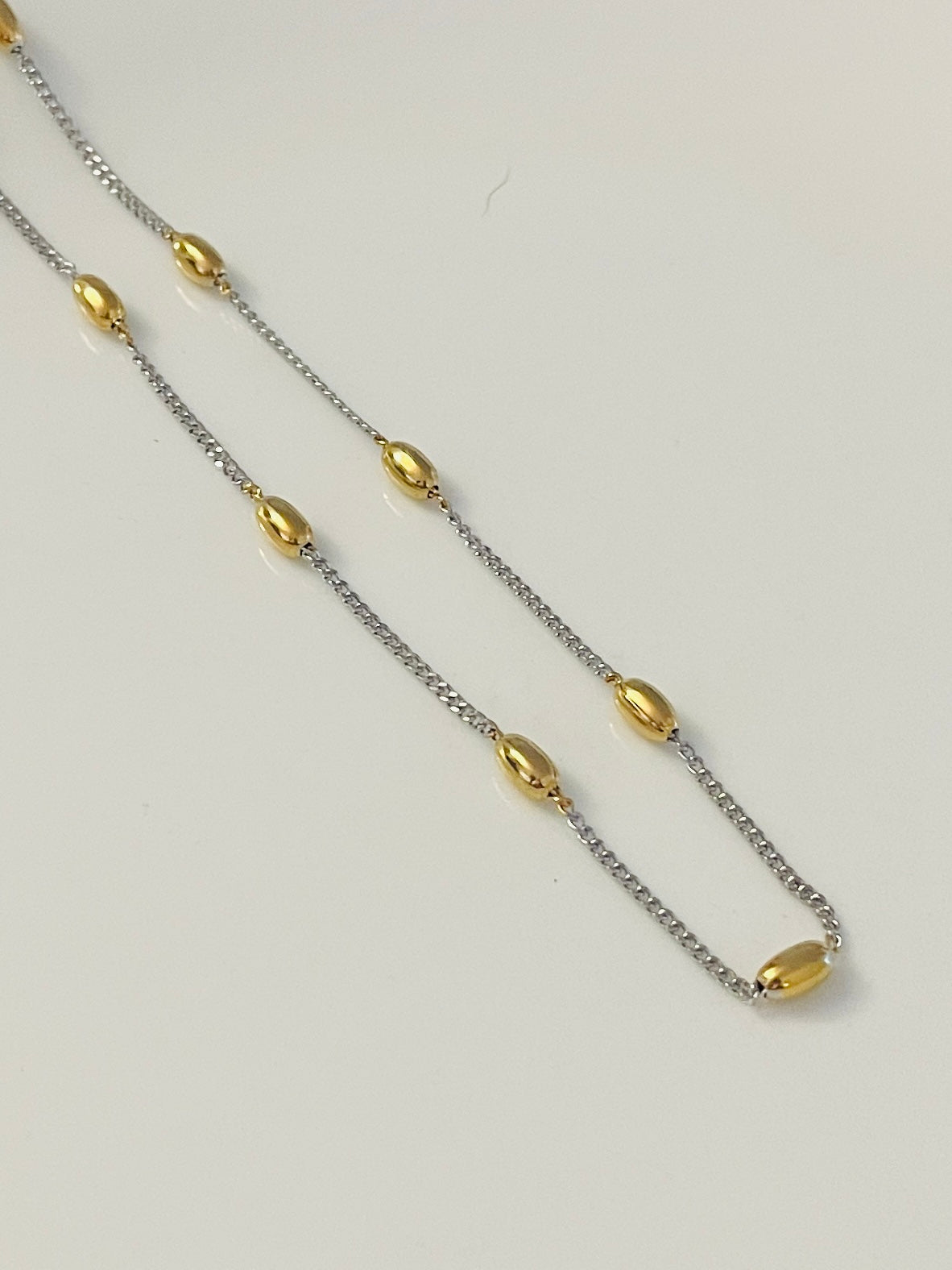 Silver necklace with gold dots